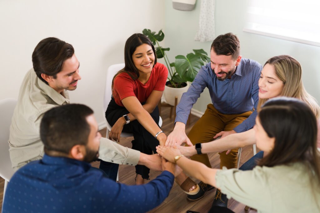 Diverse people finishing a rewarding AA meeting
